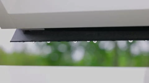 View of falling raindrops from  window frame of skylight during rain. Stock Footage 196732780