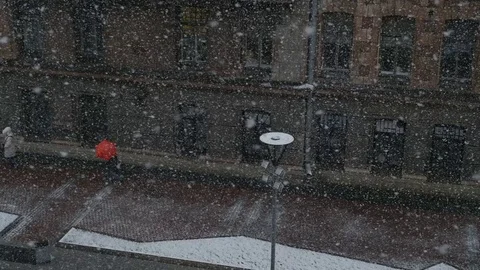 View of the falling snow against a city street background, 4k footage Stock Footage 74152588