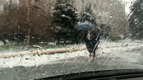 View of the falling snow through the windshield of the car with the heating Stock Footage 75478994