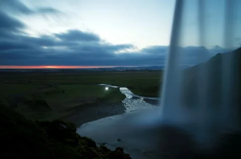 View of a falling waterfall in a mountainous area Stock Photos