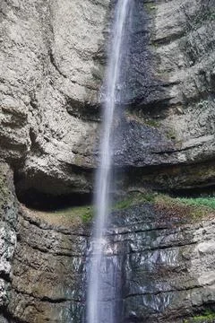 View of a falling waterfall in the mountains Stock Photos