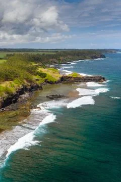 View of the famous Golden beach between black volcanic rocks on the banks of  Stock Photos