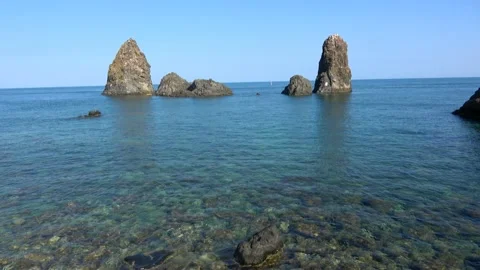 View of the Faraglioni of Acitrezza. Rocks of the Cyclops, typical lava stack Stock Footage 135905158
