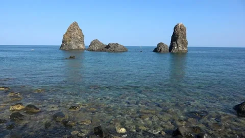 View of the Faraglioni of Acitrezza. Rocks of the Cyclops, typical lava stack Stock Footage 154084630
