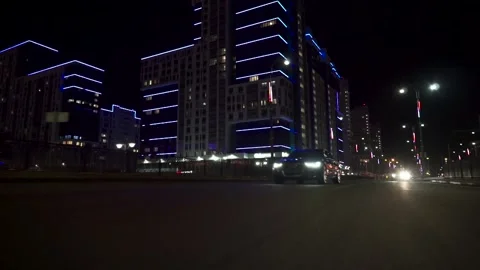 View of fast car moving on a night avenue in city, road with lights reflected on Stockbeeldmateriaal 133203516