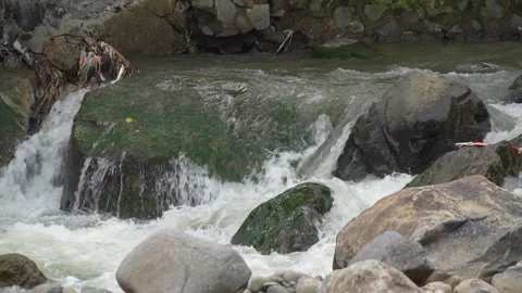 View of a fast flowing river over a collection of natural rocks. Stock Footage 327146703