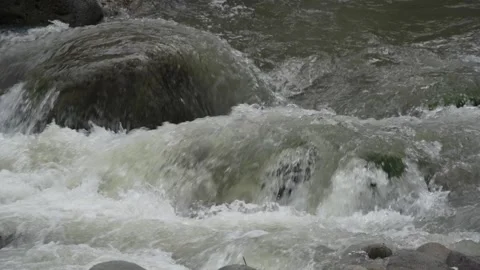 View of a fast flowing river over a collection of natural rocks. Stock Footage 327148653
