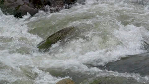 View of a fast flowing river over a collection of natural rocks. Stock Footage 327301084