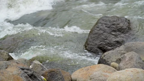 View of a fast flowing river over a collection of natural rocks. Stock Footage 327301466