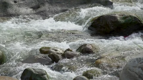 View of a fast flowing river over a collection of natural rocks. Stock Footage 327305124