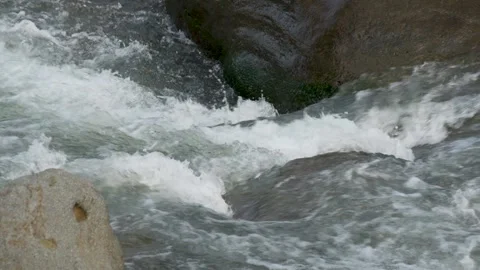 View of a fast flowing river over a collection of natural rocks. Stock Footage 327305354