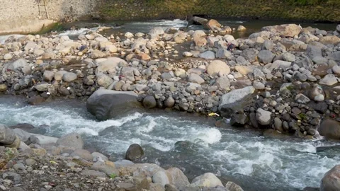 View of a fast flowing river over a collection of natural rocks. Stock Footage 327305627