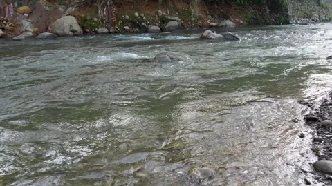 View of a fast flowing river over a collection of natural rocks. Stock Footage 327307391
