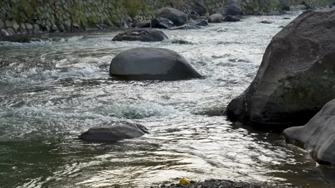 View of a fast flowing river over a collection of natural rocks. Stock Footage 327308016