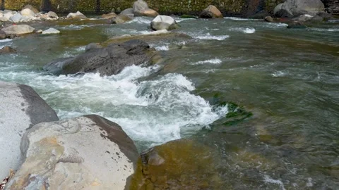 View of a fast flowing river over a collection of natural rocks. Stock Footage 327308444