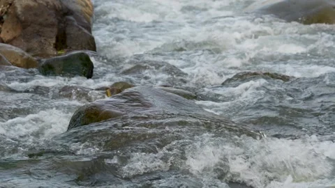 View of a fast flowing river over a collection of natural rocks. Stock Footage 327309714