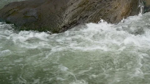 View of a fast flowing river over a collection of natural rocks. Stock Footage 327310402