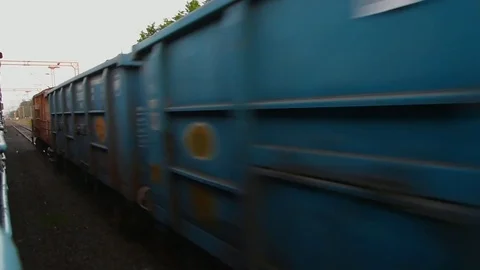 View from fast moving train,crossing stationary old Freight train, Gujarat India Stock Footage 106799333
