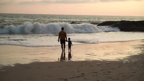 View of a father and son holding hands on a beach, Sri Lanka. Vídeos de archivo 335601960