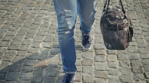 View of the feet of a man with a bag Stock Footage 49338451