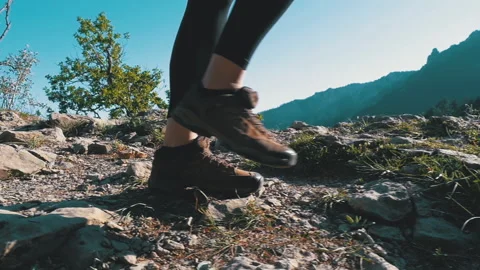 View on Feet of Traveler Woman Hiking Walking on the Top of Cliff in Mountain Stock Footage