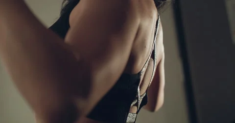 View of female back during training muscles with the simulator in a gym Stock Footage 146809178