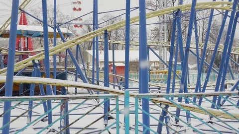 View of the Ferris wheel in the snow-covered winter city park Stock Footage 84908871