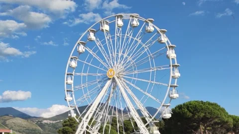 View of the Ferris Wheel on a Sunny Summer Day in Calabria, Southern Italy.  Stock Footage 202338864