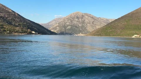 View with ferry crossing in the bay between the mountains. Sunlight gold Stock Footage 265591350