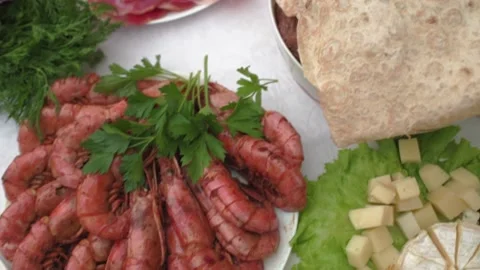 View of festive table. Plate with fried shrimps. Plate with different cheeses HD Stock Footage 141931825