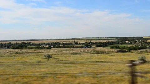 View of the field from the train.	 Stock-Footage 77862563
