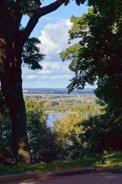 View of fields, forests and meadows on the other side of the big river. Stock Photos