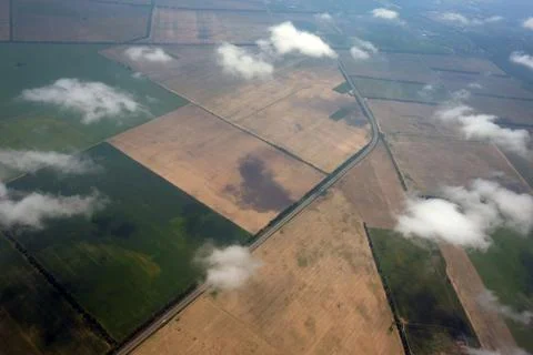 View of the fields from the window of the plane. View of the earth's surface Stock Photos