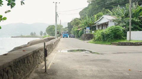 View from the final bus stop of Danzil Bus Station with a coastal road, ocean Stock Footage 331505463