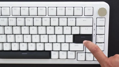 View of a finger pressing the Enter key on a mechanical keyboard. Stock Footage 338441133