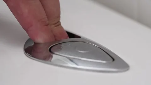 View of finger pushing button and flushing toilet. Stock Footage 282907306