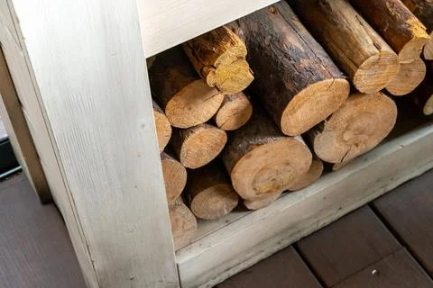 View of Fire Wood stocked inside Furniture shelf Stock Photos