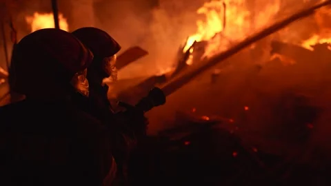 View of firefighters battling a large fire at night, Bangladesh. Video stock 335561886