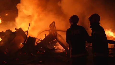 View of firefighters battling a large fire at night, Bangladesh. Video stock 335562070