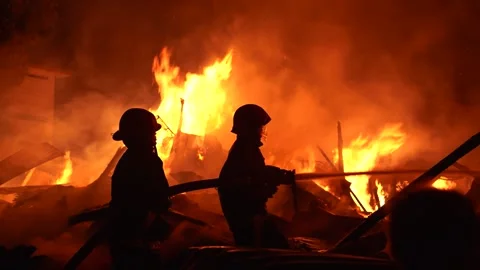 View of firefighters battling a massive blaze at night, Bangladesh. 스톡 동영상 335561819