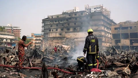 View of firefighters at a fire scene among debris, Bangladesh. 스톡 동영상 335562518