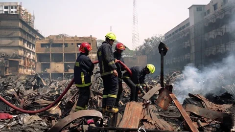 View of firefighters working at a fire scene in Dhaka, Bangladesh. Video stock 335562807