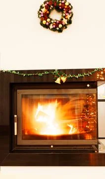 View of a fireplace with a burning fire inside Stock Photos