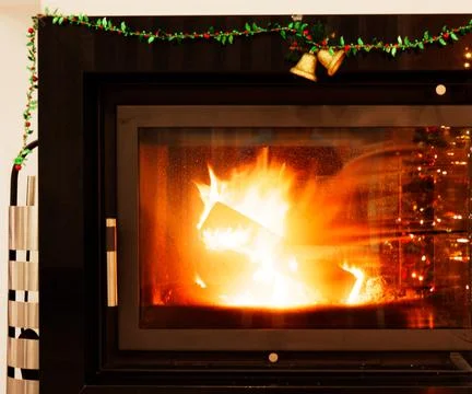 View of a fireplace with a burning fire inside Stock Photos