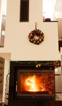 View of a fireplace with a burning fire inside Stock Photos