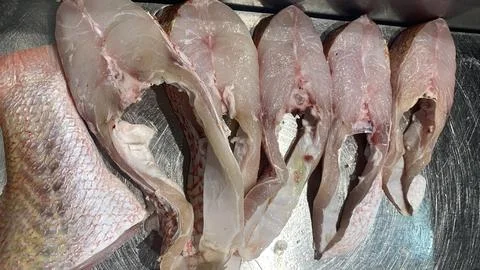 View Fish meat that has been cut and placed on a stainless steel tray for sal Stock Photos
