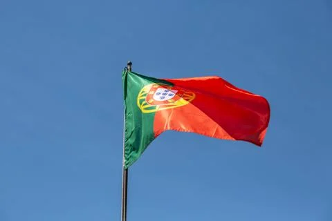 View of a flag of Portugal on a flagpole waving in the wind Stock Photos
