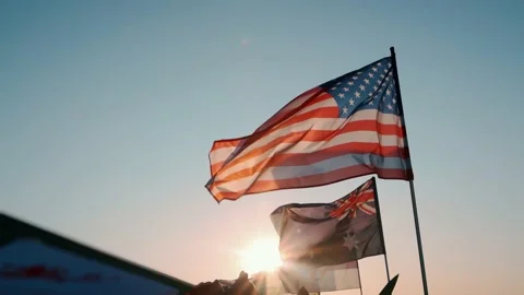 View of the flags of different countries fluttering in the wind in the sun Video stock 213718619