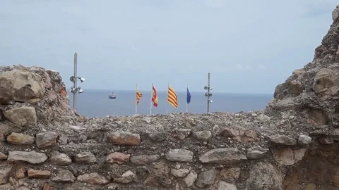 A view of flags from the ruins in Tarragona Stock Footage 97173902