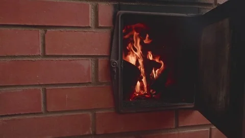 View of flame in fireplace made of red brick. Slow motion view Stock Footage 77452673